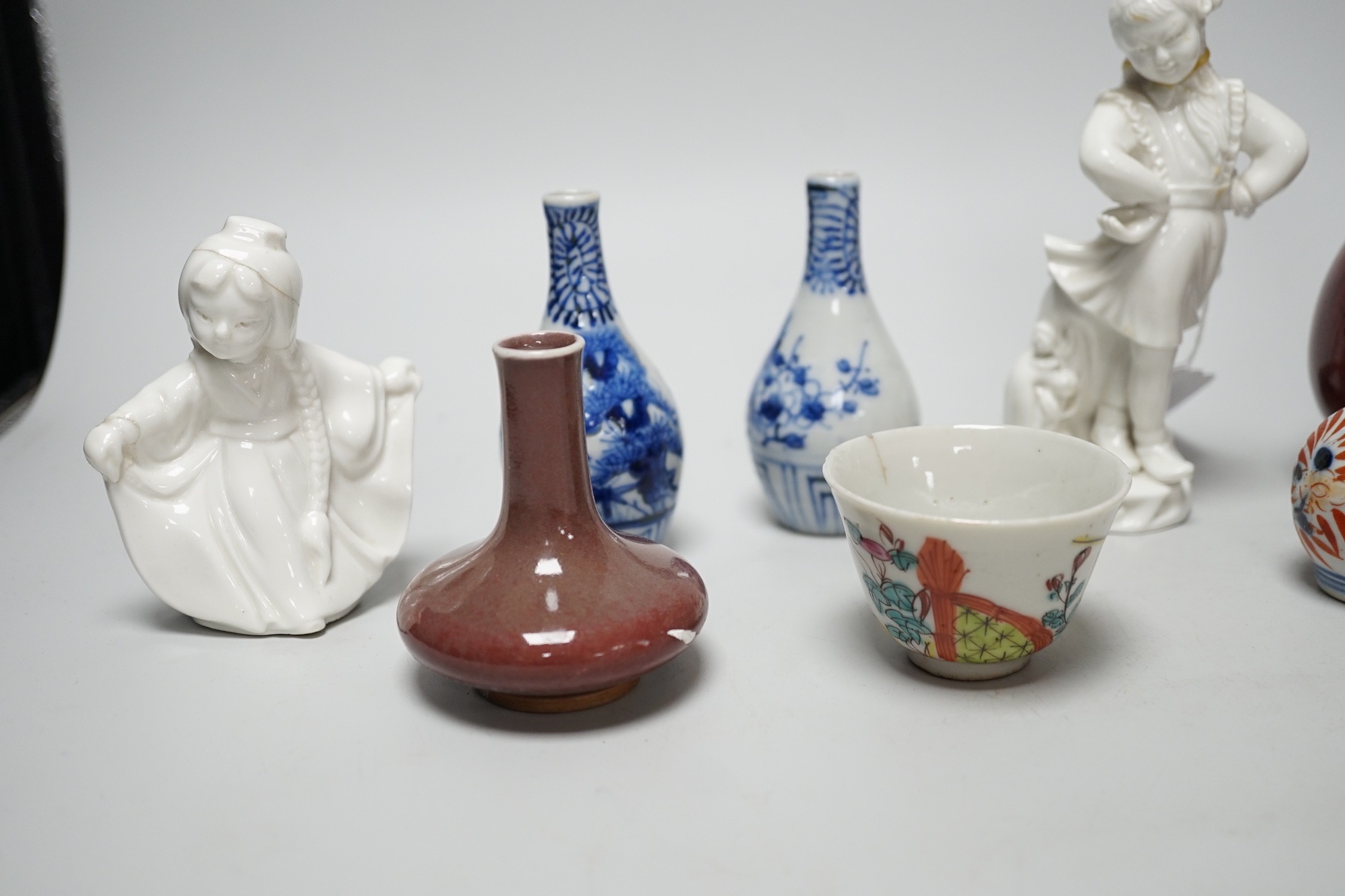 A Chinese sang de boeuf bottle neck vase, together with four Chinese miniature vases, three Chinese figures and a Chinese tea bowl, tallest 15cm